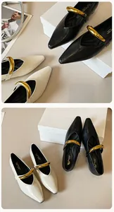 Details von Vintage-Ballerinas mit spitzer Zehenpartie und markanten goldenen Metallschnallen