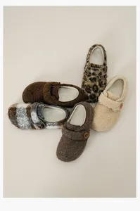 Detail of plush fleece lined Birkenstock mules in solid colors and leopard patterns