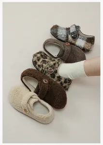 Detailed close-up of warm faux fur clogs in cream, leopard print and coffee tones