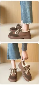 Detail of winter platform shoes featuring brown suede panels and warm fleece lining trim