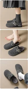 Detail view of gray felt mules featuring woven stitching and buckle strap for comfort