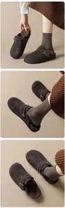 Detail of warm brown felt mule with adjustable bronze metal buckle and plush fleece lining