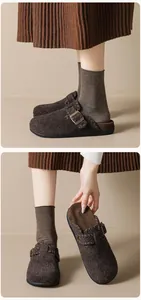 Detail of dark brown felt Birkenstock clogs with bronze buckle and soft fleece lining