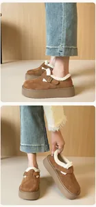 Close-up of brown suede platform Birkenstock clogs with thick white faux fur lining