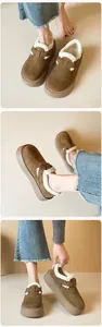 Three-way view of brown suede platform clogs with warm white faux fur lining and buckle