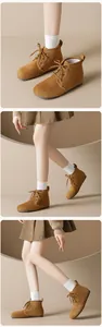 Detailed view of brown suede lace-up ankle boots with soft warm lining for winter
