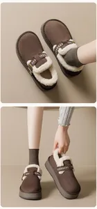 Detail of dark brown suede platform mule slippers with thick white faux fur lining