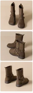 Detail of brown suede ankle boots with double metal buckle straps and round toe design