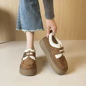 Brown suede platform snow boots with white faux shearling lining and double buckles