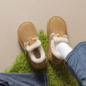 Brown platform snow boots with warm faux shearling lining and white embroidery details