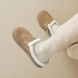 Women's brown suede clogs with warm white faux fur lining and adjustable buckle strap