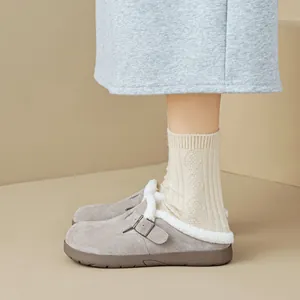 Women's grey suede Birkenstock style clogs with plush white faux fur lining and buckle