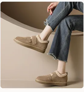 Detail of warm brown suede platform boots featuring faux shearling lining and velcro straps