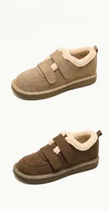 Close-up of winter platform boots with suede finish, velcro straps and warm fur lining