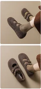 Detail view of brown felt Mary Jane shoes with double gold buckles and warm khaki socks