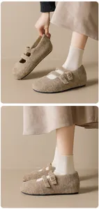 Close-up of beige wool Mary Jane flats featuring dual buckled straps and plush texture