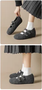 Close-up of grey wool Mary Jane shoes with double gold buckles and cozy felt texture