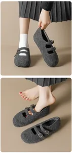 Close-up detail of dark gray wool felt Mary Jane shoes with double vintage metal buckles