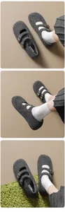 Detail view of dark grey wool Mary Jane shoes with double gold buckles and ribbed socks