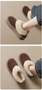Detail of warm brown suede platform snow boots with thick faux fur lining for winter