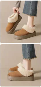 Detailed view of the platform brown suede boots with warm white faux fur lining and heel tab