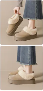 Detail of sand-colored platform snow boots with thick faux shearling trim for winter