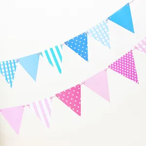 Detail of pink and blue paper bunting banners with stripes and polka dots for party decor
