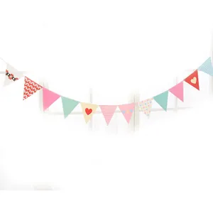 Close-up of colorful paper bunting with heart, polka dot and checkered patterns