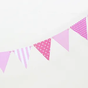 Close-up of pink paper bunting banner with stripes and polka dots for party decor