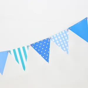 Detailed view of blue patterned paper bunting flags with stripes and polka dots