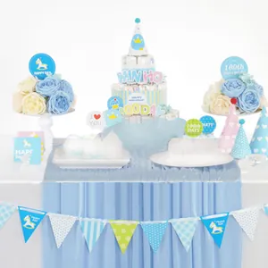 Blue and white baby birthday party decoration set with flags, hats and diaper cake decor