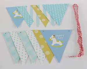 Close-up of pastel triangle bunting with rocking horse and Happy Day star designs