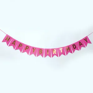Close-up of pink swallowtail banner with gold foil Happy Birthday lettering detail