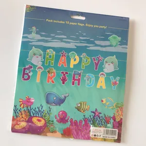 Detail of shark-themed happy birthday banner in clear plastic packaging with marine motifs