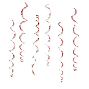 Detailed view of six metallic rose gold PVC spiral swirls for festive party decorations