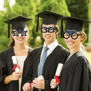 Close-up of Class of 2026 graduation photo props with blue glitter and mortarboard designs
