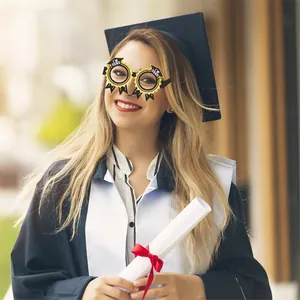 Detail of creative graduation party paper glasses with I'M DONE text and mortarboard design