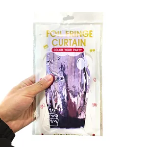 Close-up of metallic purple foil fringe curtain in clear retail packaging with hang hole