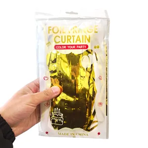 Close-up of golden foil fringe curtain in retail packaging for party decorations