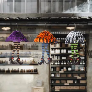 Three Halloween paper honeycomb witch legs hanging decor with striped stockings and shoes