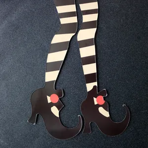 Detail of Halloween witch legs paper honeycomb decor with black shoes and striped socks