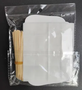 Detail of wooden stick set and double-sided adhesive dots for DIY cake topper assembly