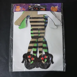 Detail of Halloween paper honeycomb ornaments showing witch boots with striped stockings