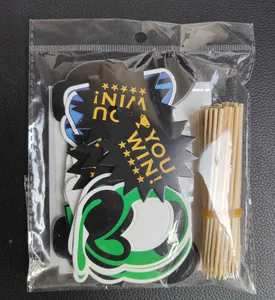 Close-up of GAME ON cake toppers set with gold YOU WIN text in clear packaging