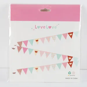 Detail of colorful heart and polka dot paper pennants in retail packaging for parties