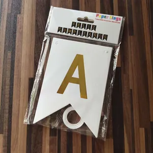 Detail view of gold foil 'A' flag from Feliz Cumpleaños banner in retail packaging