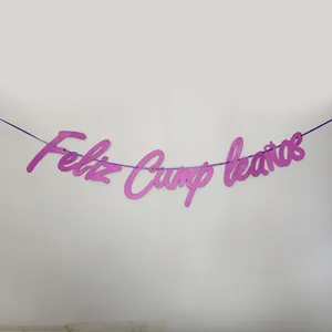 Close-up of purple glitter Feliz Cumpleaños banner with elegant script font for birthday party