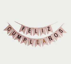 Detail of pink swallowtail banner with gold foil FELIZ CUMPLEAÑOS Spanish lettering