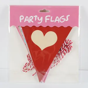 Macro view of red heart party flags with red and white cotton string in packaging