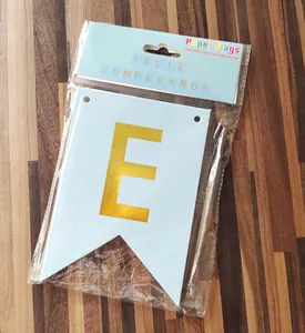 Detail of light blue and gold Feliz Cumpleaños paper flag with letter E in packaging